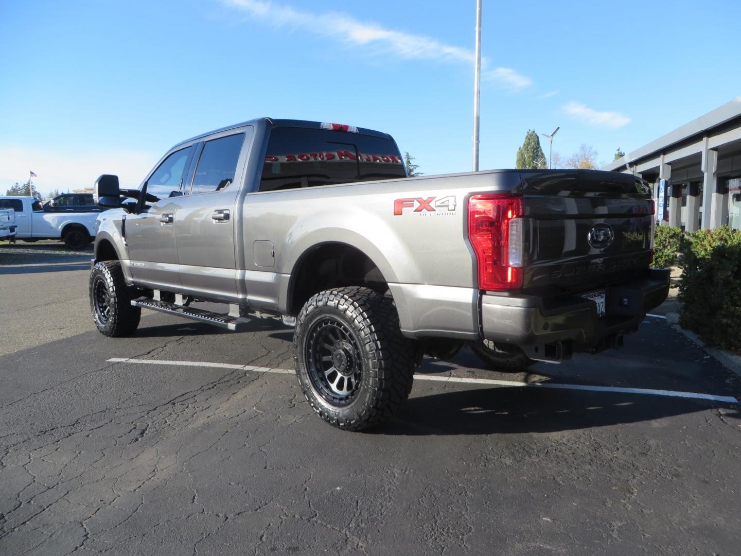 2019 CHARCOAL /BLACK Ford F-350 SD Lariat Crew Cab 4WD (1FT8W3BT7KE) with an 6.7L V8 OHV 16V DIESEL engine, 6A transmission, located at 2630 Grass Valley Highway, Auburn, CA, 95603, (530) 508-5100, 38.937893, -121.095482 - Leveled Superduty sitting on 20" XD series wheels, 35" Nitto Ridge Grappler tires, window tint, and has Firestone Air bags. - Photo#5